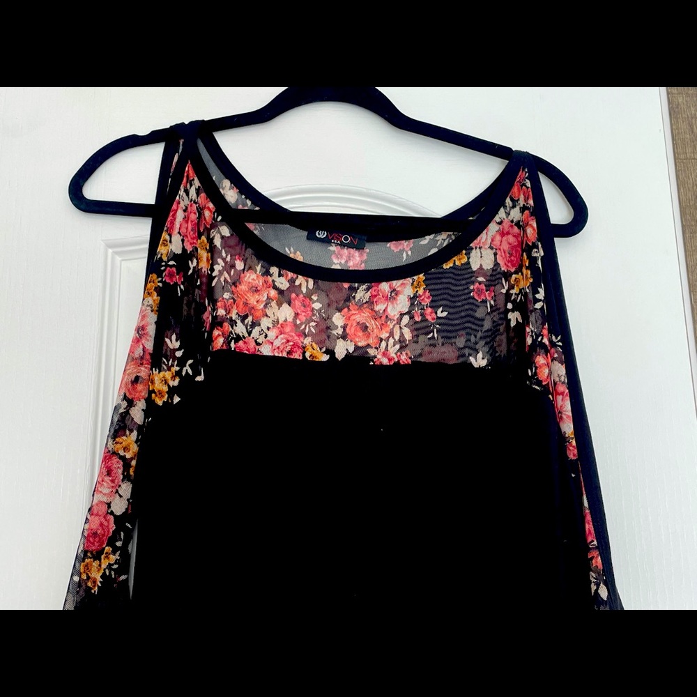 This shirt is a women’s extra large with a beautiful flower print on the sleeve
